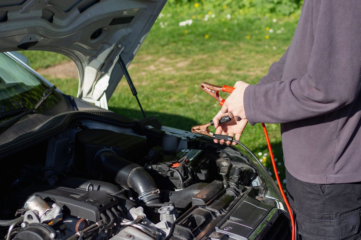 Jump leads ready to connect to a car battery